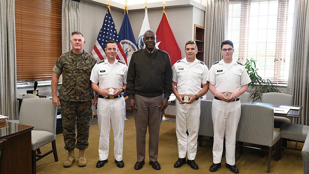 Maj. Gen. Cedric T. Wins ’85 (center) congratulates Col. Patrick Looney, Riley Shultz ’24, Ethan Webster ’25, and Ryan Manning ’26