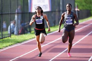 two female athletes running on outdoor track