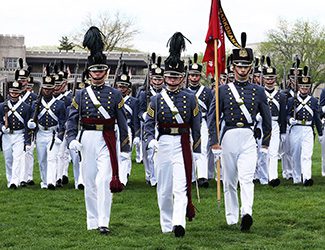 Cadet leadership marching toward the camera during a parade